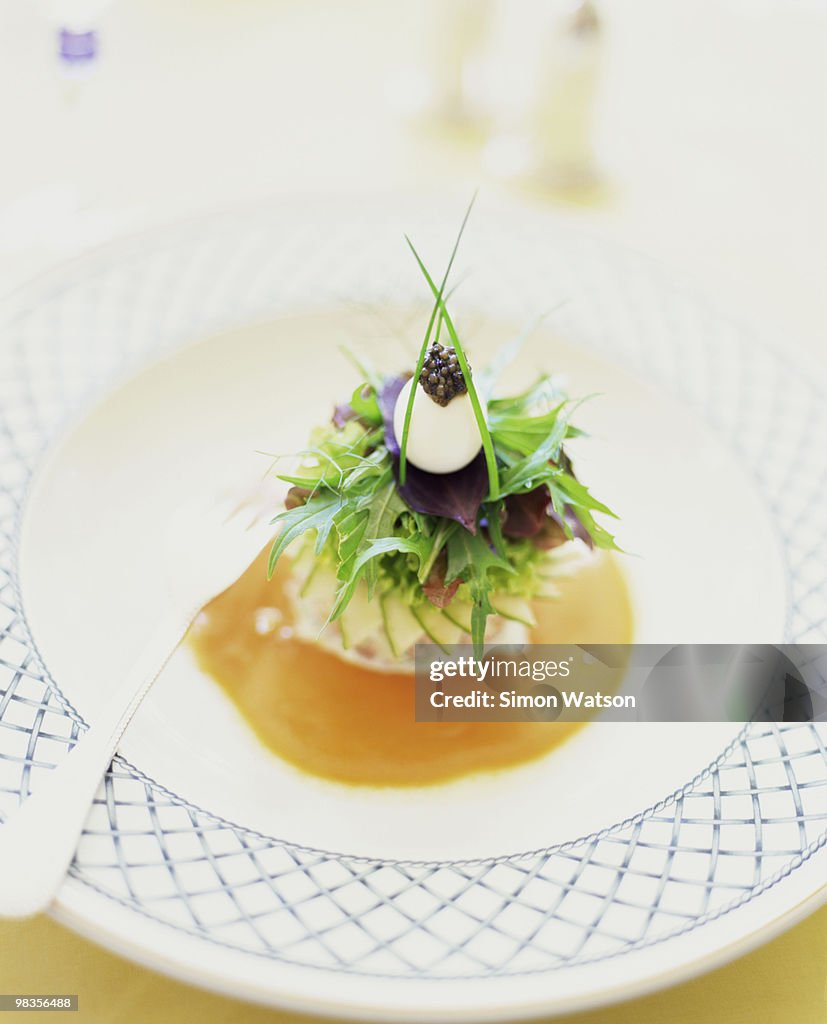Ornate French appetizer with quail egg and caviar