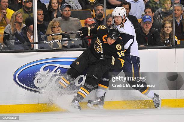 Marco Sturm of the Boston Bruins checks Toni Lydman of the Buffalo Sabres at the TD Garden on April 8, 2010 in Boston, Massachusetts.