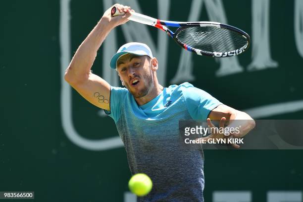 Australia's John Millman returns against Luxembourg's Gilles Muller during a Men's singles first round match at the ATP Nature Valley International...