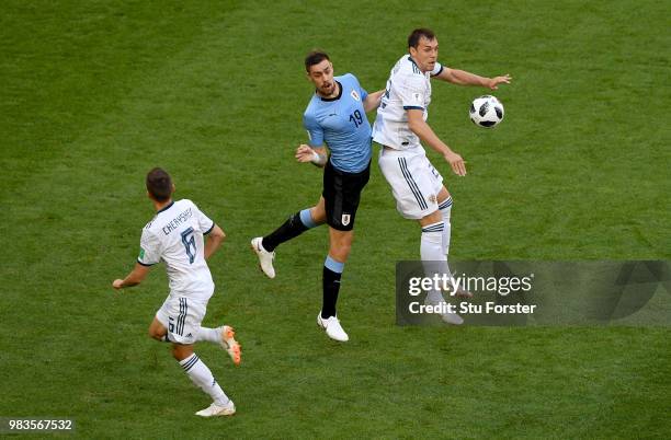 Artem Dzyuba of Russia is challenged by Sebastian Coates of Uruguay during the 2018 FIFA World Cup Russia group A match between Uruguay and Russia at...