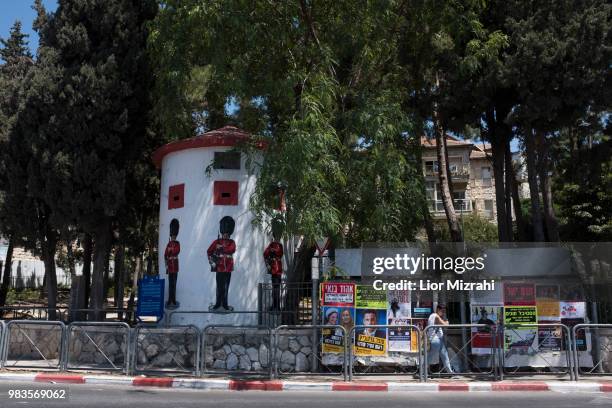 An Israeli woman walks next to an old British military Pillbox with pictures of Grenadier Guards on June 25, 2018 in Jerusalem, Israel. Britain's...