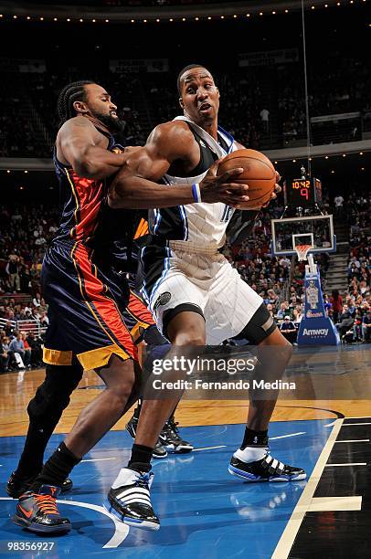 Dwight Howard of the Orlando Magic moves the ball against Ronny Turiaf of the Golden State Warriors during the game on March 3, 2010 at Amway Arena...