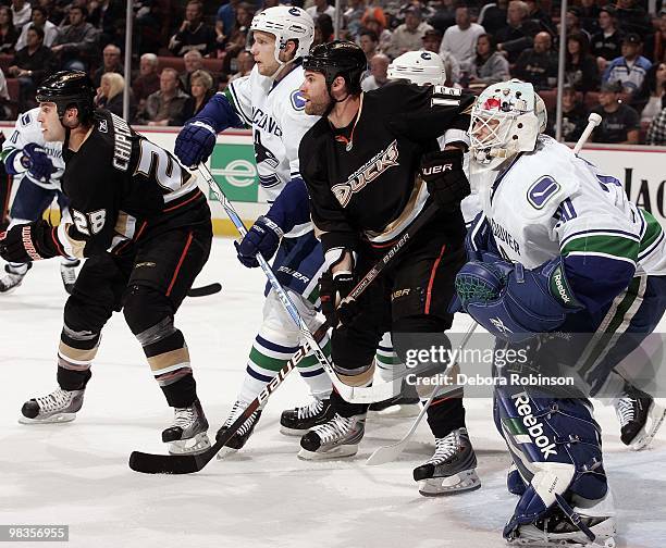Kyle Chipchura and Mike Brown of the Anaheim Ducks defend against against Andrew Raycroft and Alexander Edler of the Vancouver Canucks during the...