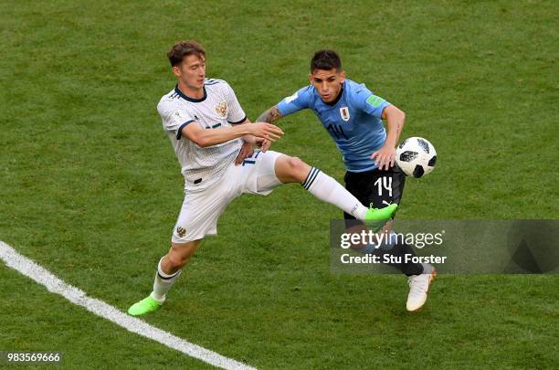 Alexey Miranchuk of Russia tackles Lucas Torreira of Uruguay during the 2018 FIFA World Cup Russia group A match between Uruguay and Russia at Samara...