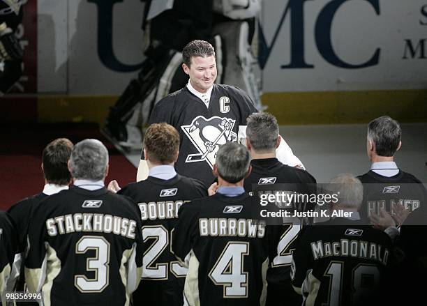 Mario Lemieux greets the rest of the Penguins alumni during the pre game ceremony to celebrate the final regular season game at Mellon Arena on April...