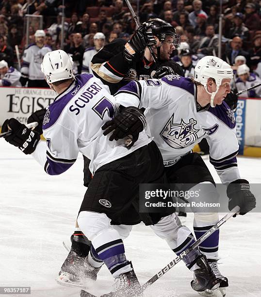 Matt Greene and Rob Scuderi of the Los Angeles Kings get tangled up with Mike Brown of the Anaheim Ducks during the game on April 6, 2010 at Honda...