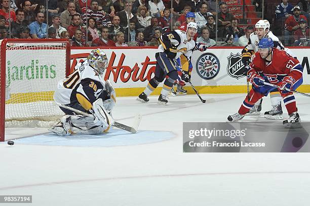 Ryan Miller of Buffalo Sabres blocks a shot of Benoit Pouliot of the Montreal Canadiens during the NHL game on April 3, 2010 at the Bell Center in...