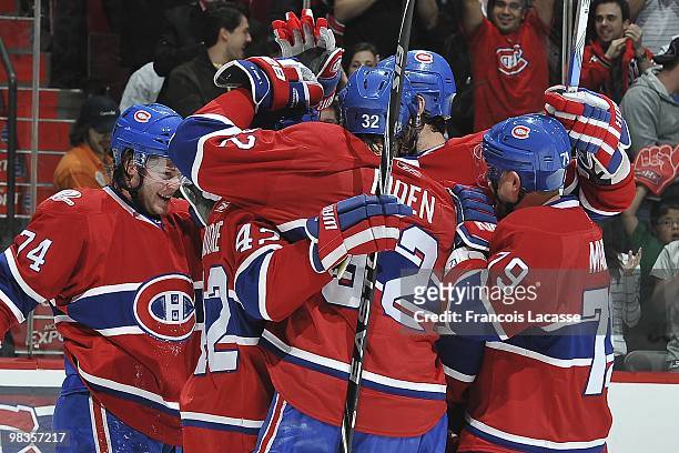 Travis Moen of Montreal Canadiens celebrates a goal with teammate Andrei Markov and Sergei Kostitsyn during the NHL game against the Buffalo Sabres...