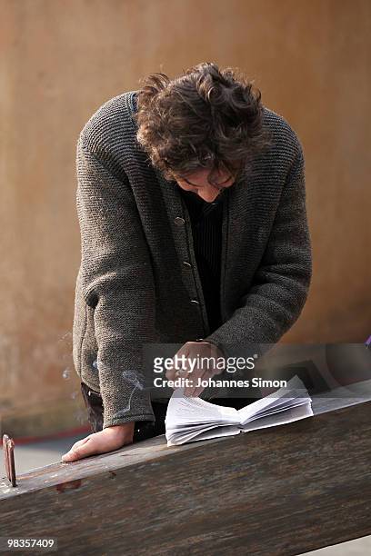 German theatre director Christian Stueckl reads the text book ahead of a passion play rehearsal on April 9, 2010 in Oberammergau, Germany. The...