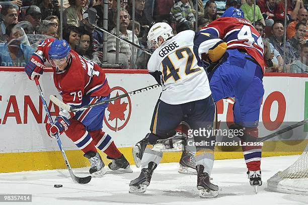 Andrei Markov of Montreal Canadiens skates with the puck in front of Nathan Gerbe of the Buffalo Sabres during the NHL game on April 3, 2010 at the...