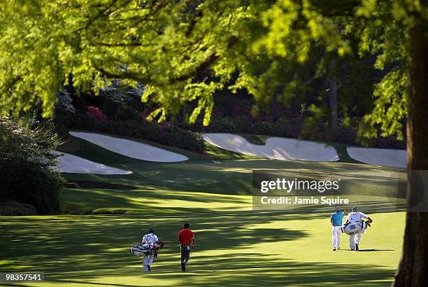 Ryo Ishikawa of Japan walks with Anthony Kim and their caddies on the 13th hole during the second round of the 2010 Masters Tournament at Augusta...