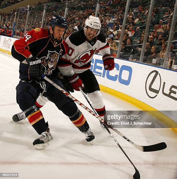 Bryan McCabe of the Florida Panthers tangles with Jay Pandolfo of the New Jersey Devils at the BankAtlantic Center on April 8, 2010 in Sunrise,...