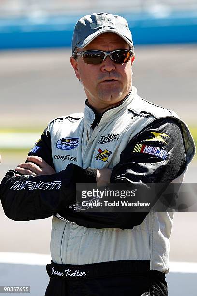 Jason Keller, driver of the TriStar Motorsports Chevrolet, looks on from the grid during qualifying for the NASCAR Nationwide Series Bashas'...