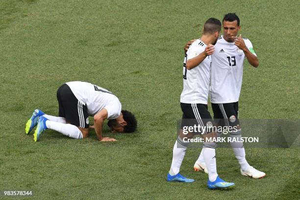 Egypt's forward Mohamed Salah kneels to celebrate his opening goal during the Russia 2018 World Cup Group A football match between Saudi Arabia and...