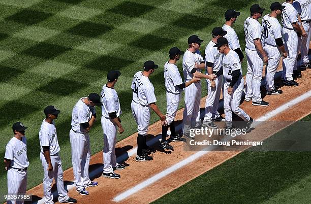 Manager Jim Tracy of the Colorado Rockies greets his players during player introductions as they host the San Diego Padres during MLB action on...