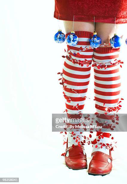 woman with legs decorate for christmas with balls - legs in stockings stock pictures, royalty-free photos & images