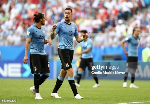 Sebastian Coates of Uruguay talks to teammate Martin Caceres during the 2018 FIFA World Cup Russia group A match between Uruguay and Russia at Samara...