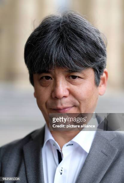 June 2018, Germany, Stuttgart: The Japanese composer Toshio Hosokawa stands in front of the Opera House. On order of the Opera Stuttgart he is...