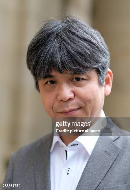 June 2018, Germany, Stuttgart: The Japanese composer Toshio Hosokawa stands in front of the Opera House. On order of the Opera Stuttgart he is...