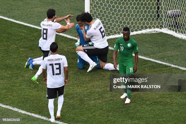 Egypt's goalkeeper Essam El Hadary is congratulated by his teammates after saving a penalty during the Russia 2018 World Cup Group A football match...