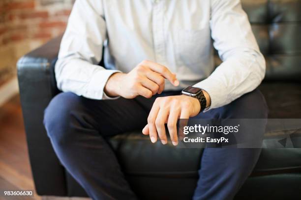 businessman using smart watch - animal hand stock pictures, royalty-free photos & images