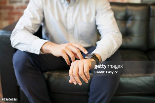 businessman using smart watch - animal hand stock pictures, royalty-free photos & images