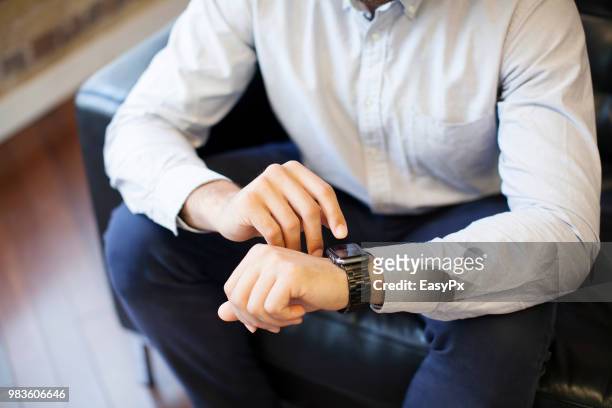 businessman using smart watch - animal hand stock pictures, royalty-free photos & images