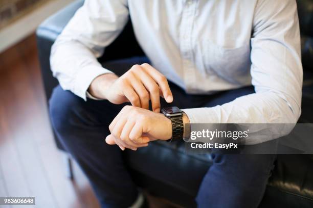 businessman using smart watch - animal hand stock pictures, royalty-free photos & images