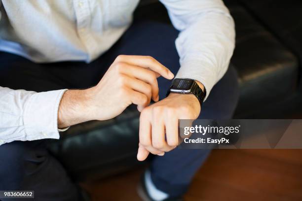 businessman using smart watch - animal hand stock pictures, royalty-free photos & images