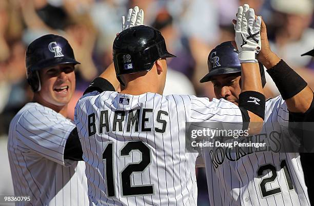 Clint Barmes of the Colorado Rockies is welcomed home by Troy Tulowitzki and Miguel Olivo after they scored on Barmes' eighth inning home run off of...