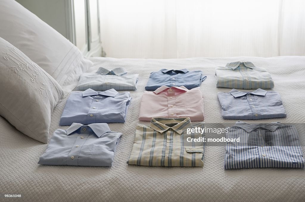 Clean shirts ordered on a bed