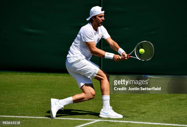 Thanasi Kokkinakis of Australia plays a backhand against Marcelo Arevalo of El Salvador during the Wimbledon Lawn Tennis Championships Qualifying at...