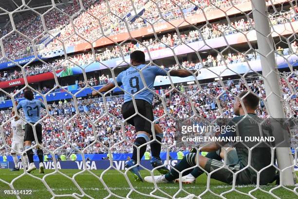 Uruguay's forward Luis Suarez celebrates past Russia's goalkeeper Igor Akinfeev after Uruguay's second goal during the Russia 2018 World Cup Group A...