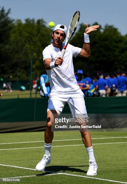 Thanasi Kokkinakis of Australia plays a backhand volley against Marcelo Arevalo of El Salvador during the Wimbledon Lawn Tennis Championships...