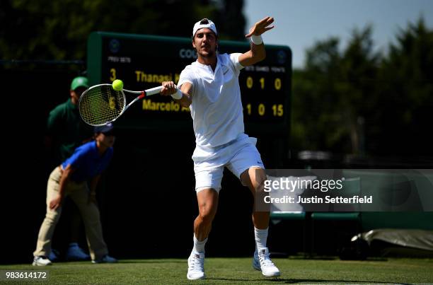 Thanasi Kokkinakis of Australia plays a forehand against Marcelo Arevalo of El Salvador during the Wimbledon Lawn Tennis Championships Qualifying at...