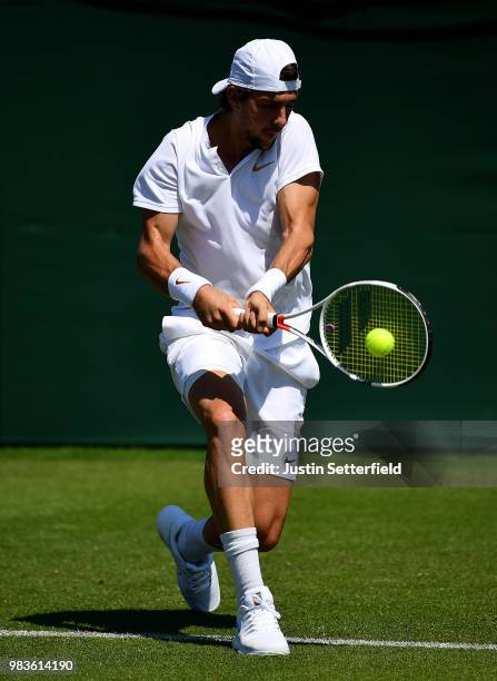 Thanasi Kokkinakis of Australia plays a backhand against Marcelo Arevalo of El Salvador during the Wimbledon Lawn Tennis Championships Qualifying at...