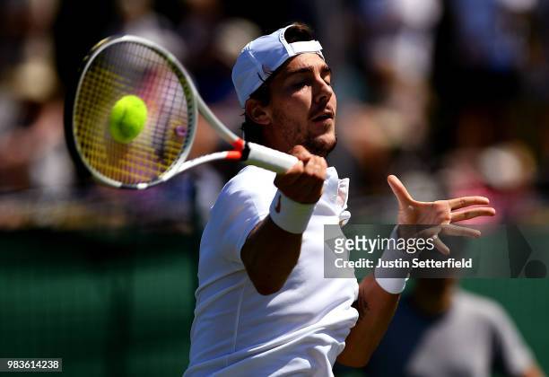 Thanasi Kokkinakis of Australia plays a forehand against Marcelo Arevalo of El Salvador during the Wimbledon Lawn Tennis Championships Qualifying at...