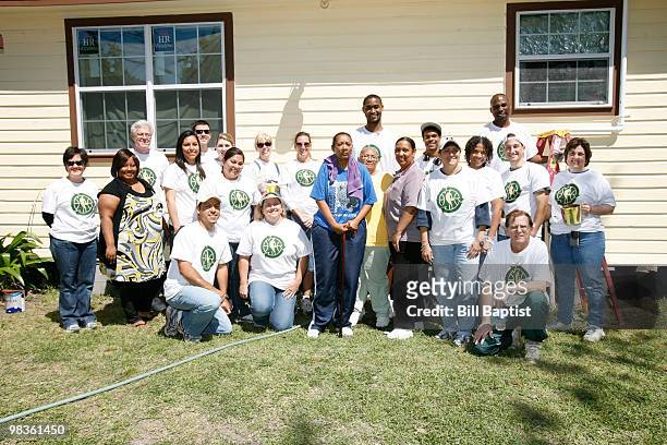 Hilton Armstrong of the Houston Rockets stands with HP volunteers who helped paint Emily Elmore's house during NBA Green Week on April 8, 2010 in...