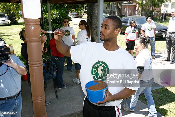 Hilton Armstrong of the Houston Rockets helps paint Emily Elmore's house during NBA Green Week on April 8, 2010 in Houston, Texas. NOTE TO USER: User...