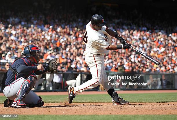 Edgar Renteria of the San Francisco Giants hits a two run home run in the ninth inning to tie the game at 4-4 against the Atlanta Braves on Opening...