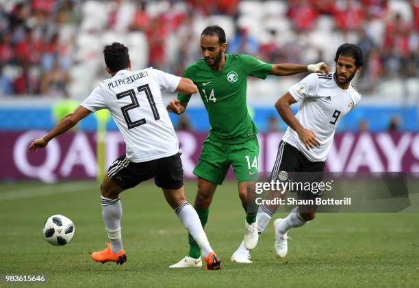 Abdullah Otayf of Saudi Arabia is challenged by Trezeguet of Egypt and Marwan Mohsen of Egypt during the 2018 FIFA World Cup Russia group A match...