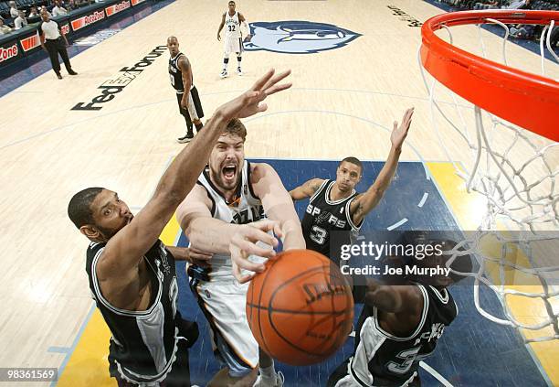 Marc Gasol of the Memphis Grizzlies goes up for a shot against Tim Duncan, George Hill and Antonio McDyess of the San Antonio Spurs during the game...