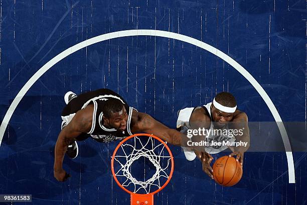 Zach Randolph of the Memphis Grizzlies rebounds against DeJuan Blair of the San Antonio Spurs during the game at the FedExForum on March 6, 2010 in...