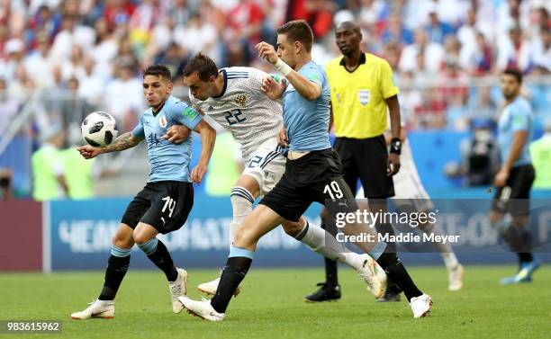 Artem Dzyuba of Russia battles for possession with Sebastian Coates of Uruguay during the 2018 FIFA World Cup Russia group A match between Uruguay...