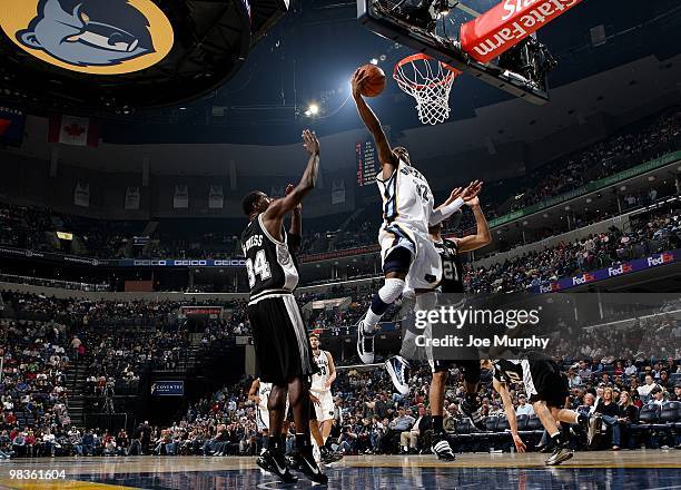 Mayo of the Memphis Grizzlies shoots a layup against Antonio McDyess and Tim Duncan of the San Antonio Spurs during the game at the FedExForum on...