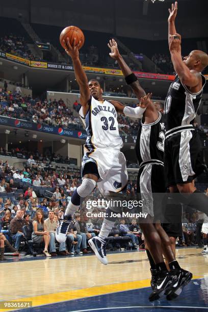 Mayo of the Memphis Grizzlies shoots a layup against Antonio McDyess and Keith Bogans of the San Antonio Spurs during the game at the FedExForum on...