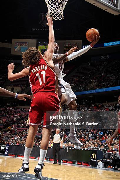 Terrence Williams of the New Jersey Nets shoots a layup against Anderson Varejao of the Cleveland Cavaliers during the game at the IZOD Center on...