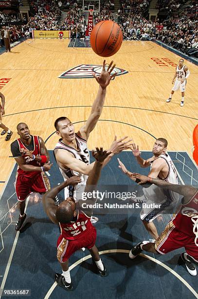 Yi Jianlian of the New Jersey Nets shoots a layup over J.J. Hickson of the Cleveland Cavaliers during the game at the IZOD Center on March 3, 2010 in...