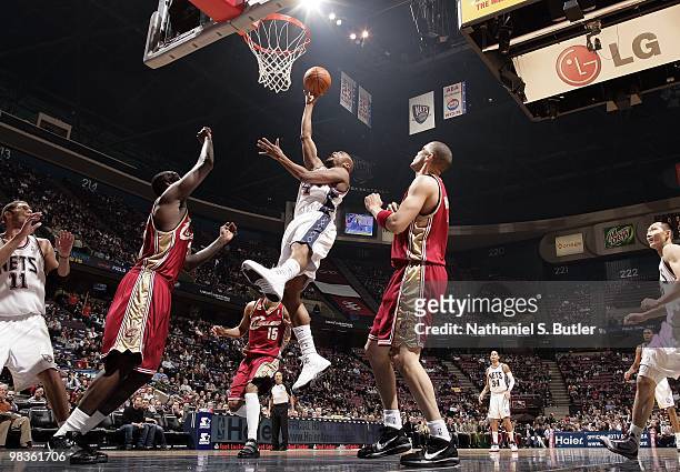 Trenton Hassell of the New Jersey Nets shoots a layup against J.J. Hickson and Anthony Parker of the Cleveland Cavaliers during the game at the IZOD...