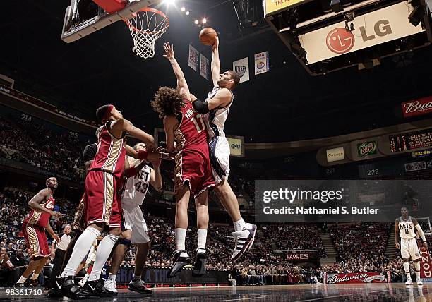 Brook Lopez of the New Jersey Nets goes up for a shot against Anderson Varejao of the Cleveland Cavaliers during the game at the IZOD Center on March...